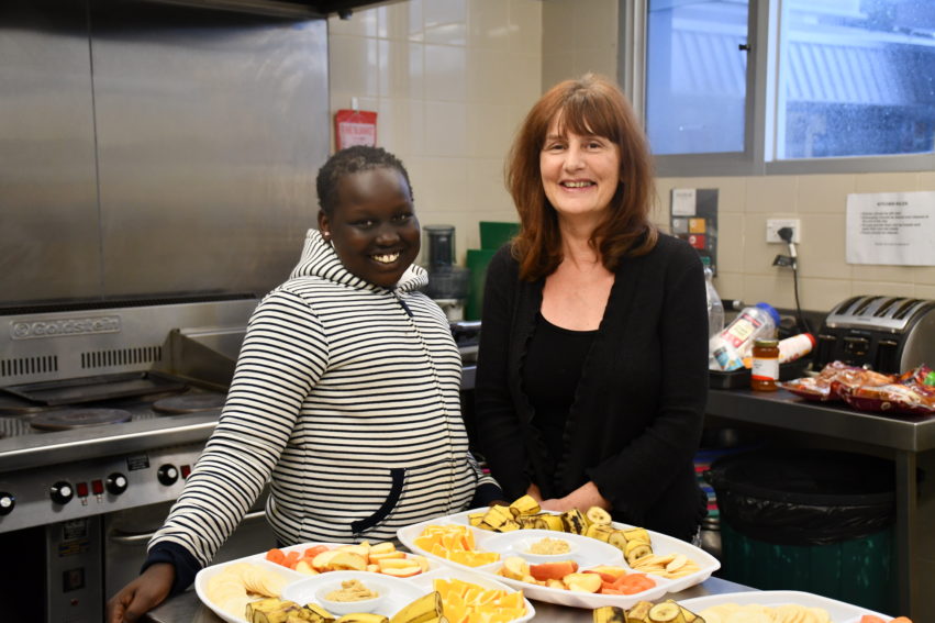 Child and Volunteer in the Kitchen